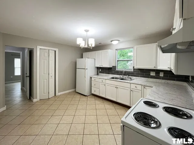 a kitchen with a sink a stove and cabinets