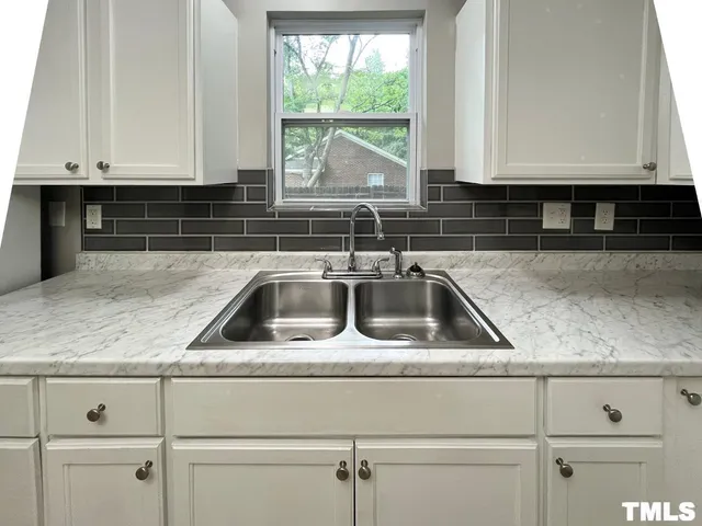 a kitchen with a sink and cabinets