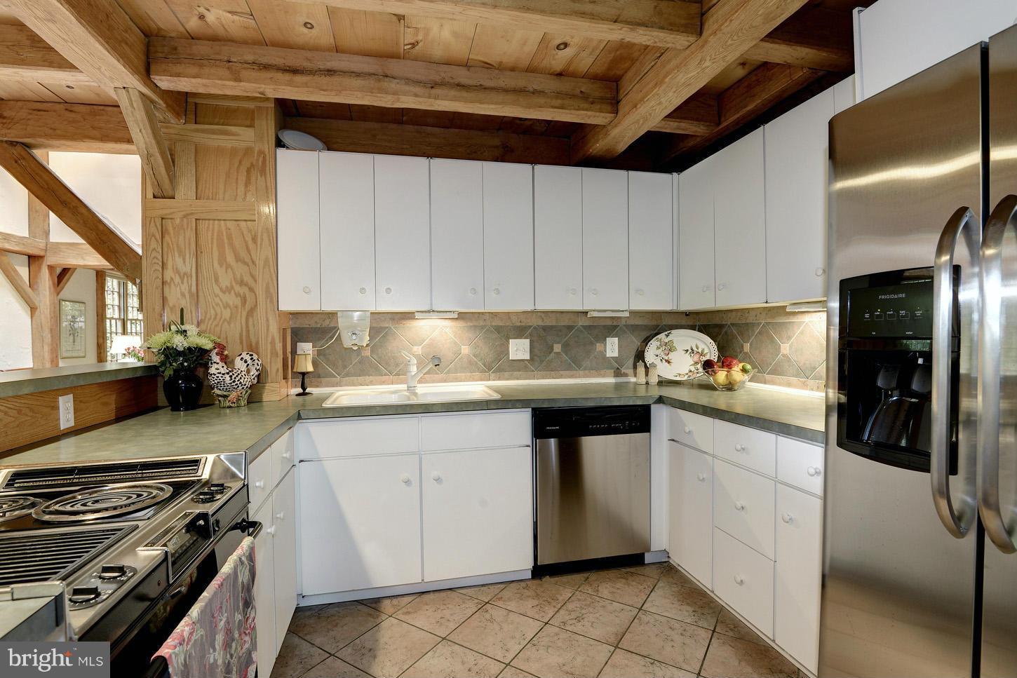 11545 Springridge Road Potomac, MD 20854 - Photo 11 of 30 a kitchen with a sink a stove and cabinets