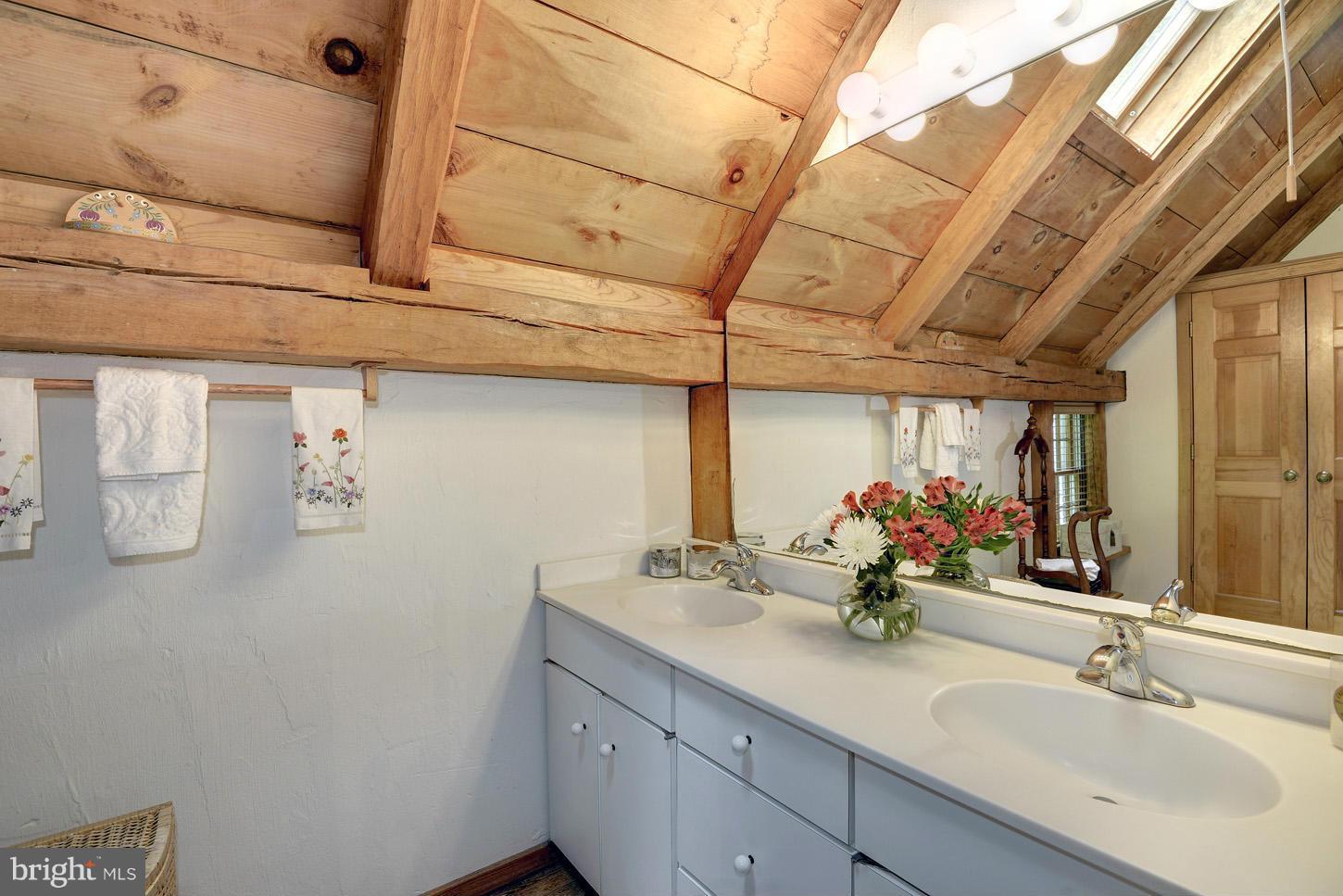 11545 Springridge Road Potomac, MD 20854 - Photo 15 of 30 a bathroom with a double vanity sink and a mirror