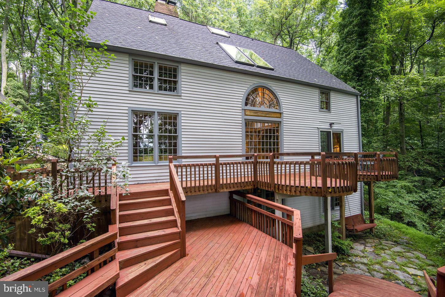 11545 Springridge Road Potomac, MD 20854 - Photo 29 of 30 a view of a house with wooden deck and furniture