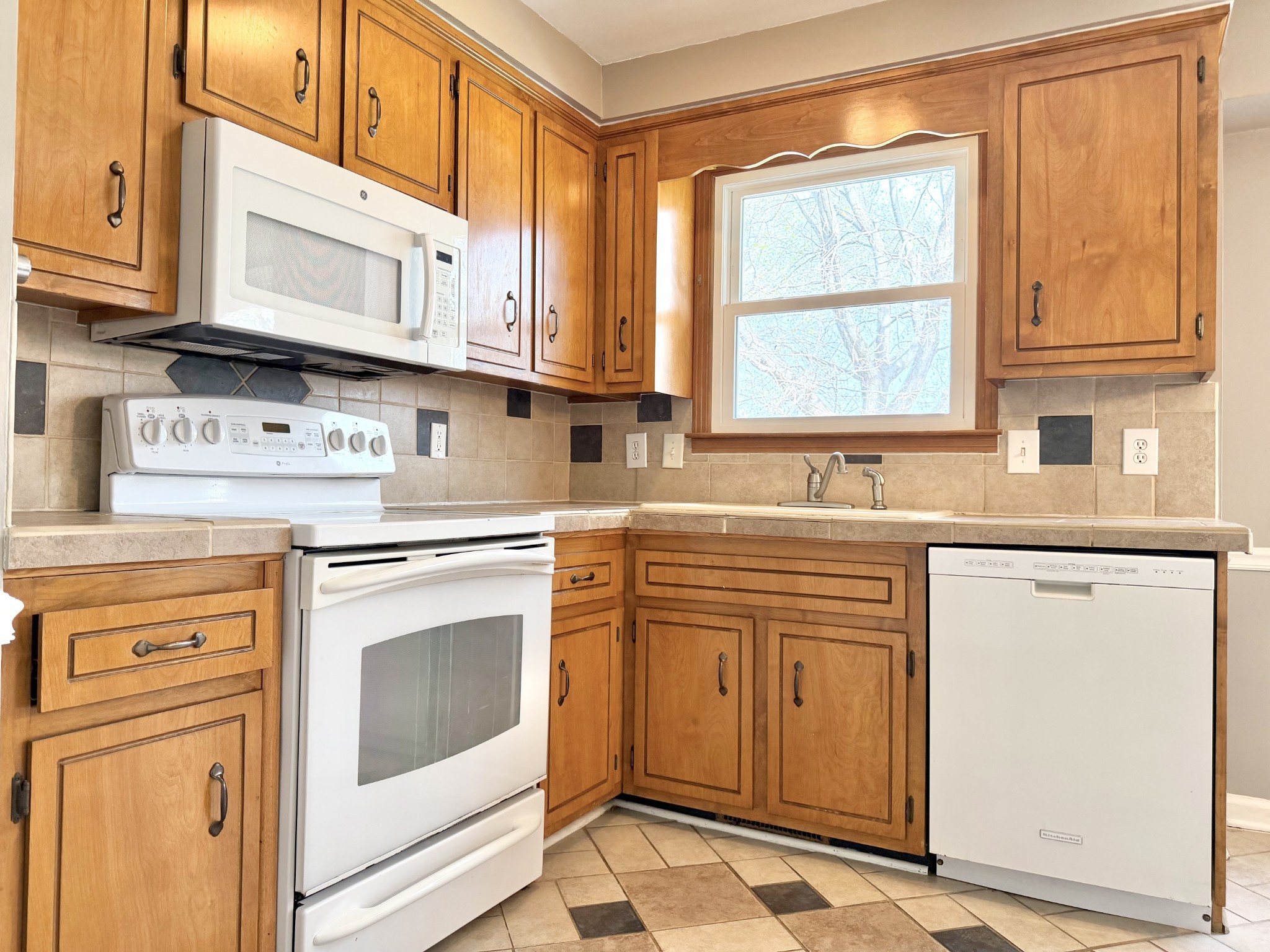 3411 Polly Drive Clarksville, TN 37042 - Photo 12 of 28 a kitchen with stainless steel appliances granite countertop white cabinets sink and window