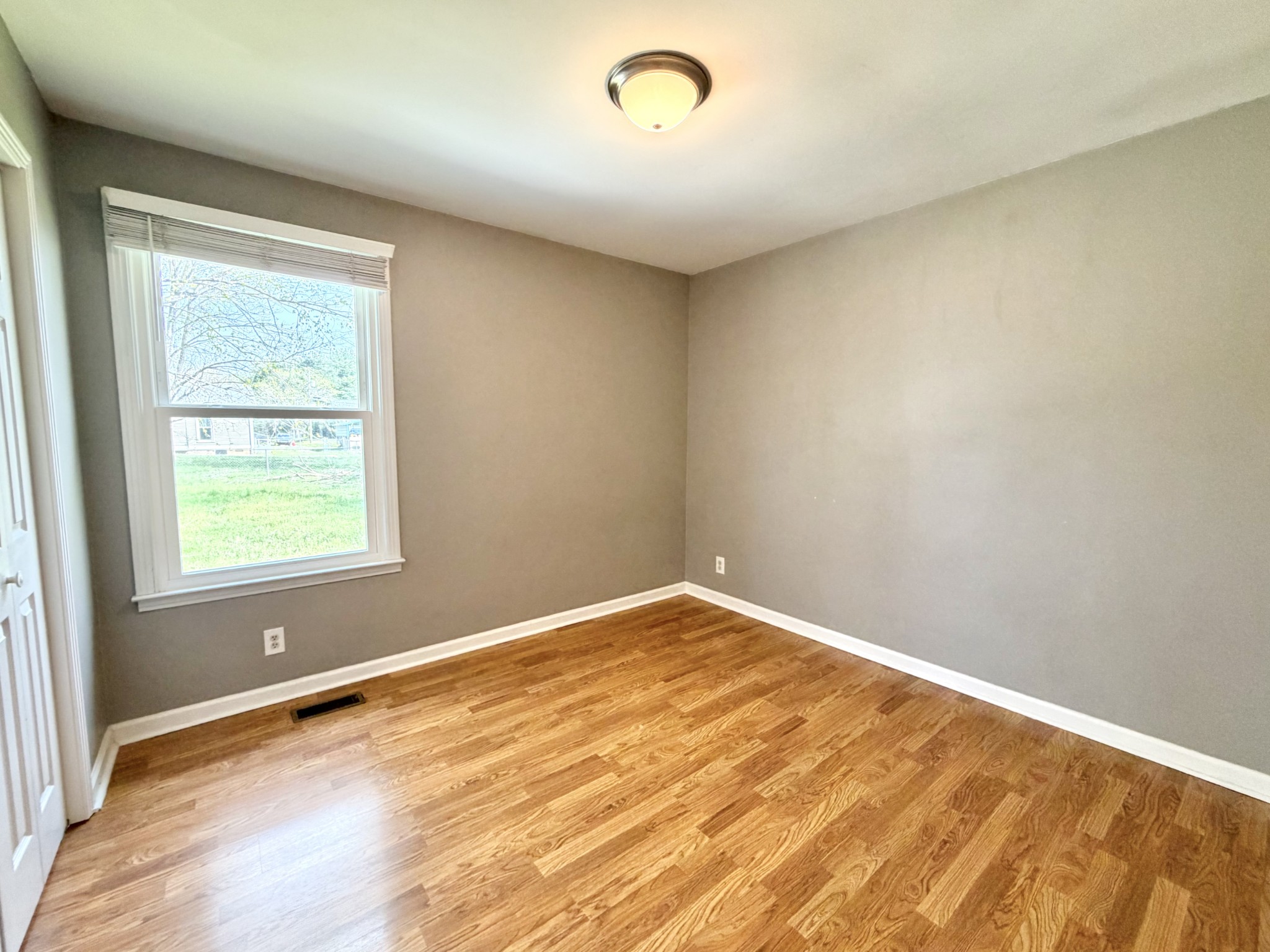 3411 Polly Drive Clarksville, TN 37042 - Photo 16 of 28 an empty room with wooden floor and windows
