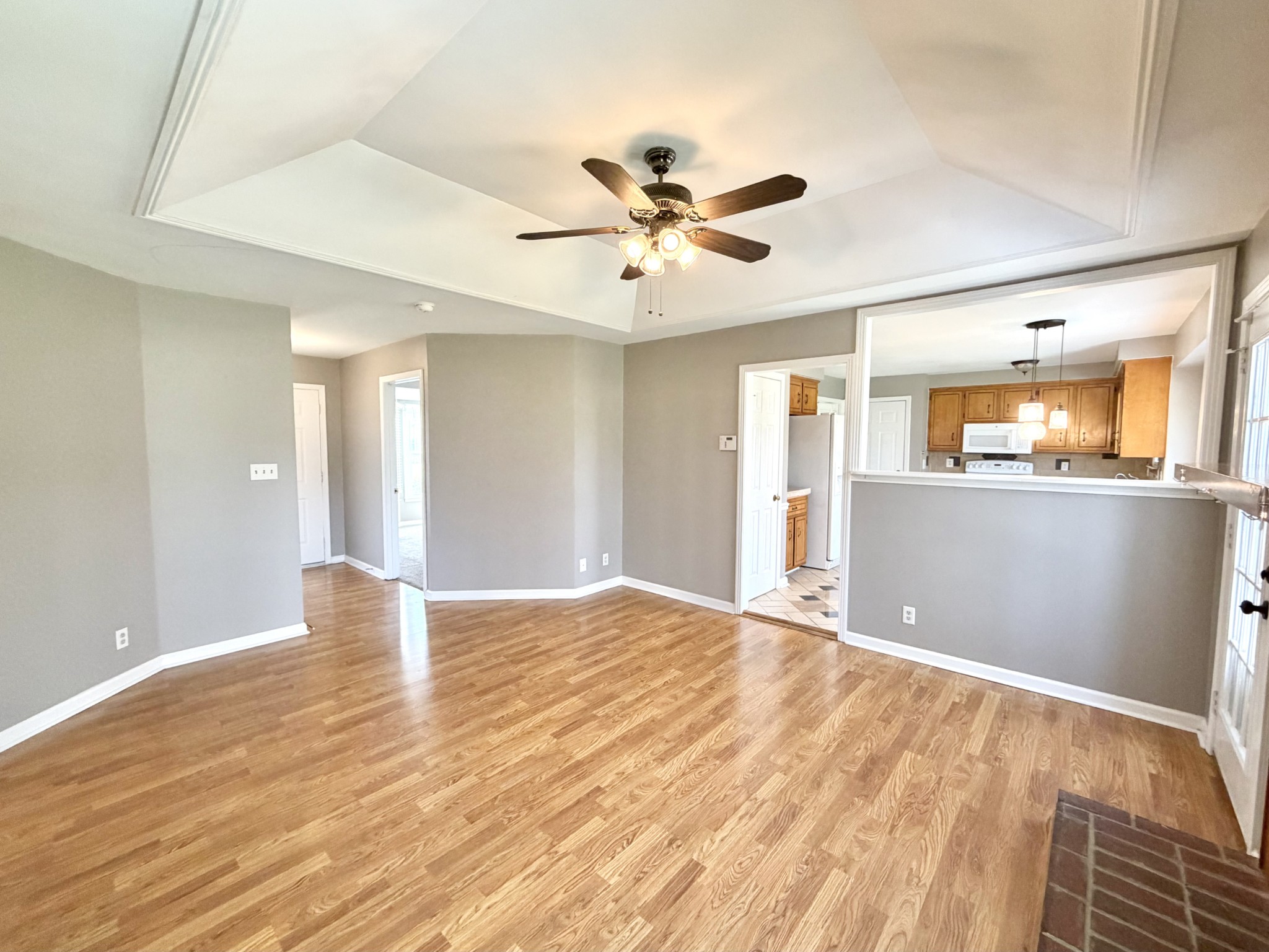 3411 Polly Drive Clarksville, TN 37042 - Photo 5 of 28 a view of an empty room with wooden floor and a ceiling fan