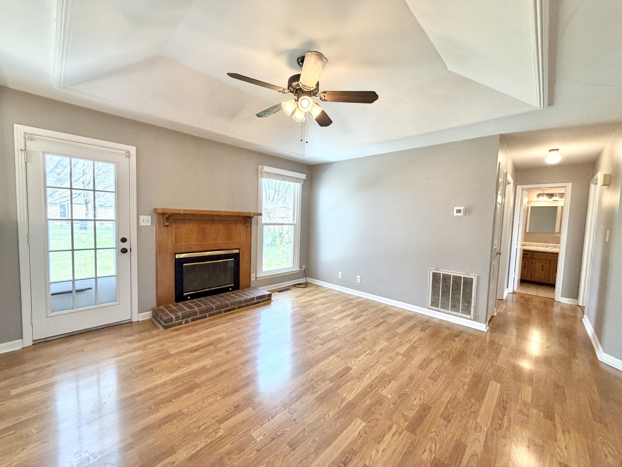 3411 Polly Drive Clarksville, TN 37042 - Photo 7 of 28 a view of a livingroom with a fireplace a ceiling fan and wooden floor