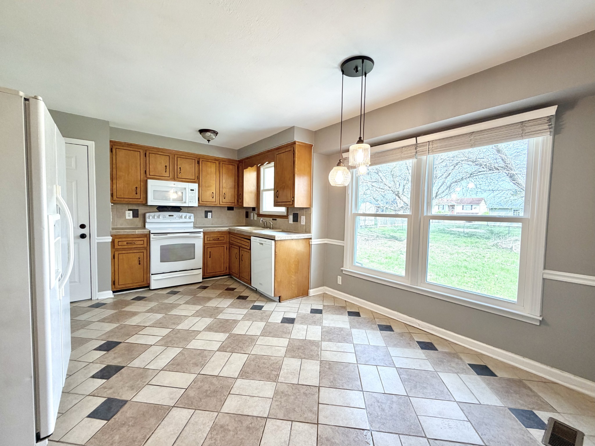 3411 Polly Drive Clarksville, TN 37042 - Photo 9 of 28 a kitchen with a stove a sink dishwasher a refrigerator and cabinets