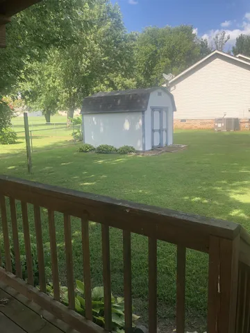 a balcony with view of trees in the background