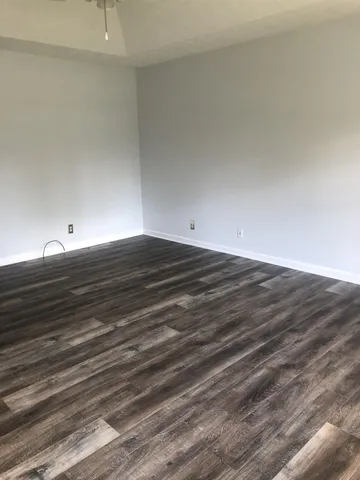 a view of an empty room and wooden floor