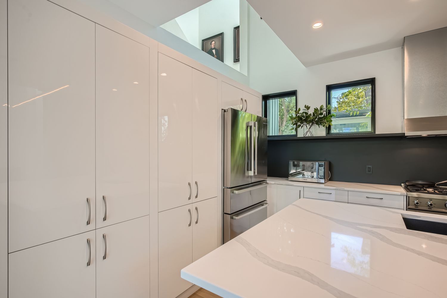 7525 Delafield Lane, Unit A Austin, TX 78752 - Photo 11 of 33 a kitchen with stainless steel appliances a refrigerator and cabinets