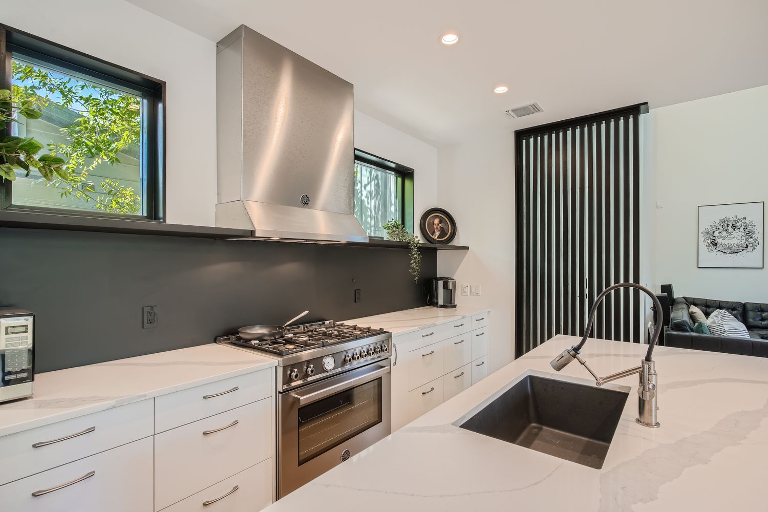 7525 Delafield Lane, Unit A Austin, TX 78752 - Photo 12 of 33 a kitchen with a stove and a white cabinets