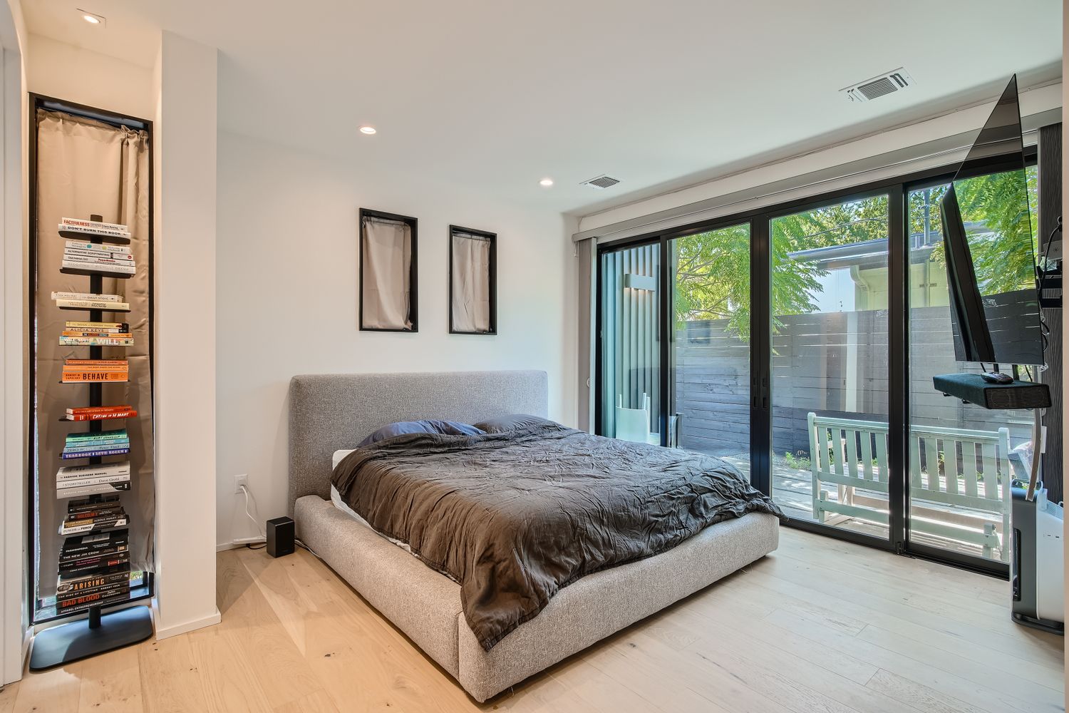 7525 Delafield Lane, Unit A Austin, TX 78752 - Photo 16 of 33 a bedroom with a large bed and a flat tv screen