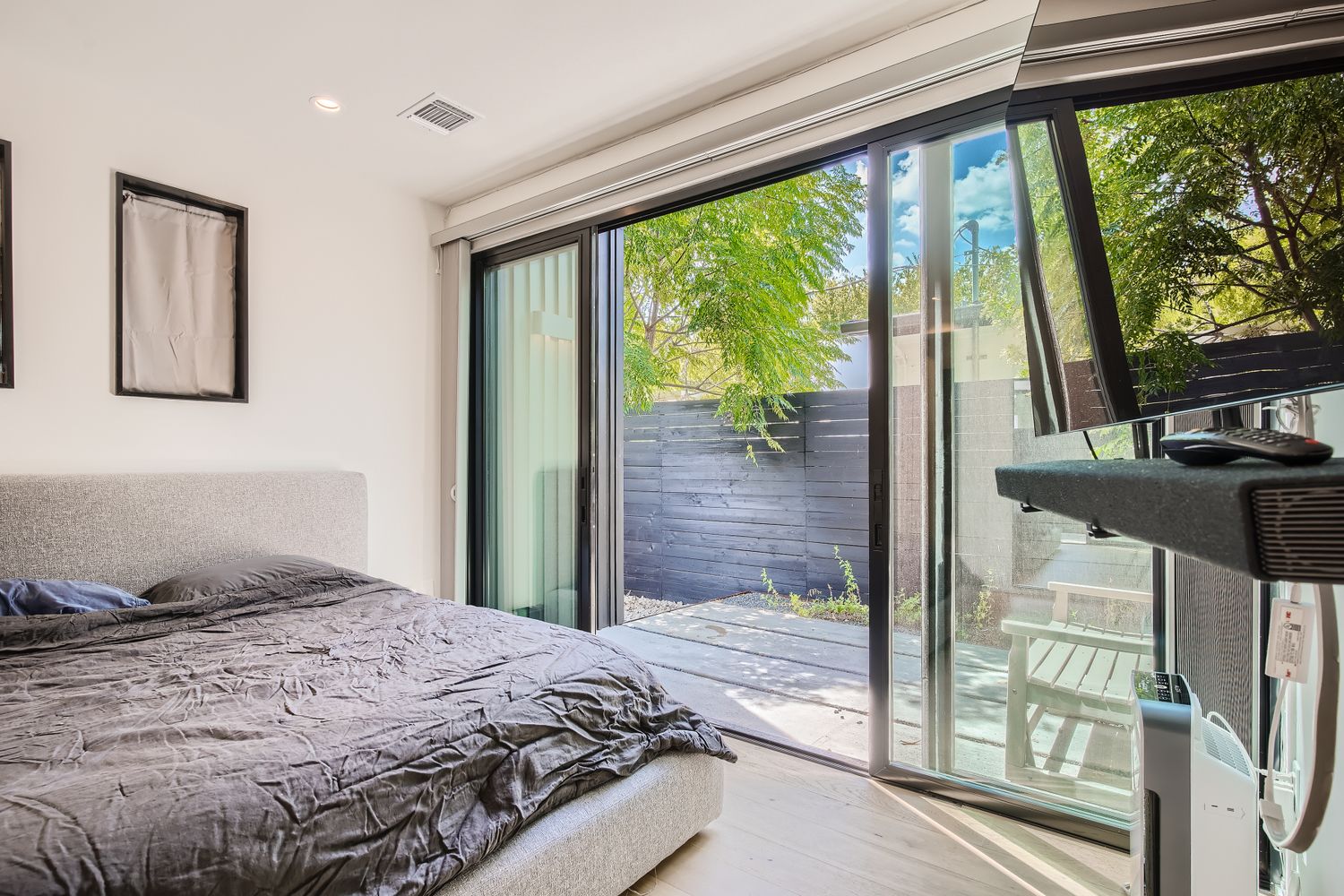 7525 Delafield Lane, Unit A Austin, TX 78752 - Photo 17 of 33 a bedroom with a bed and glass door