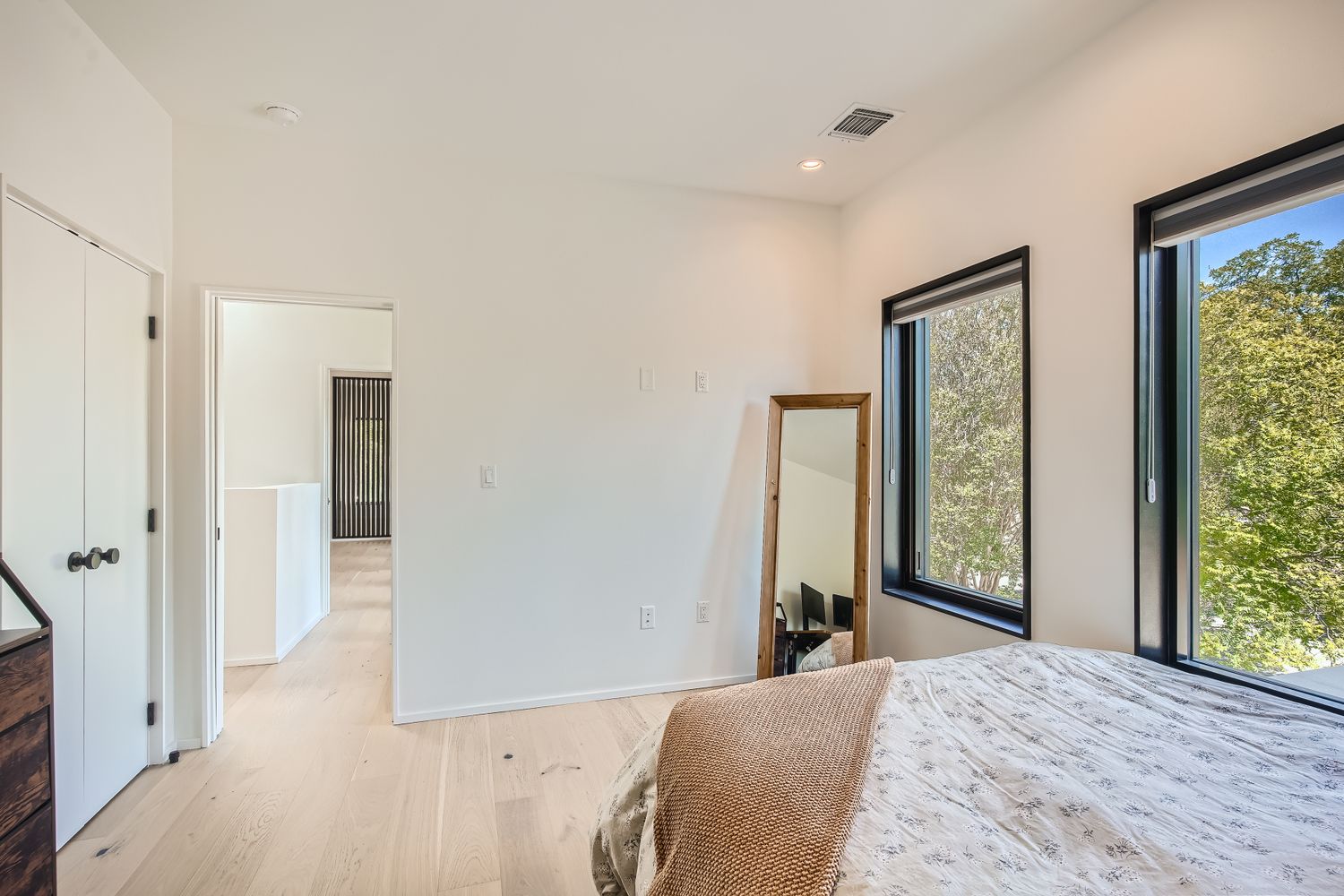 7525 Delafield Lane, Unit A Austin, TX 78752 - Photo 26 of 33 a bedroom with a bed and a large mirror