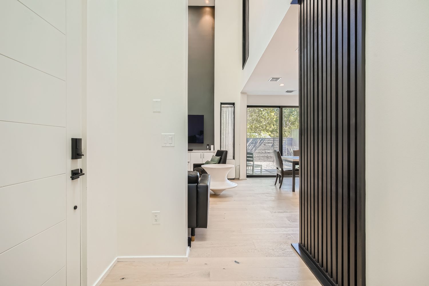 7525 Delafield Lane, Unit A Austin, TX 78752 - Photo 3 of 33 a view of a hallway with wooden floor and windows