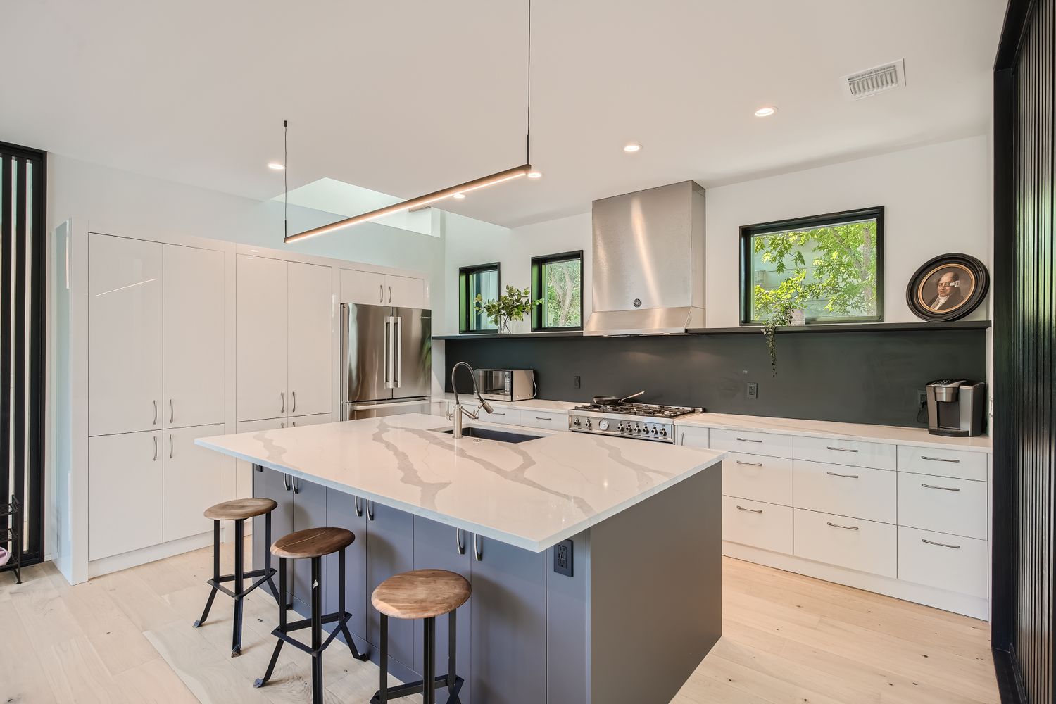7525 Delafield Lane, Unit A Austin, TX 78752 - Photo 8 of 33 a kitchen with a table chairs refrigerator and cabinets