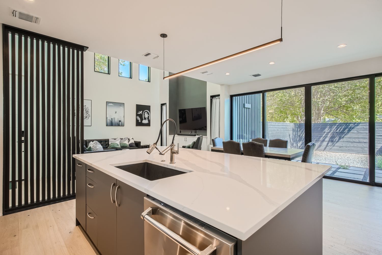 7525 Delafield Lane, Unit A Austin, TX 78752 - Photo 10 of 33 a large kitchen with kitchen island a sink appliances and a large window