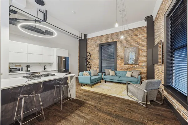 a kitchen with stainless steel appliances granite countertop a stove a sink and a refrigerator