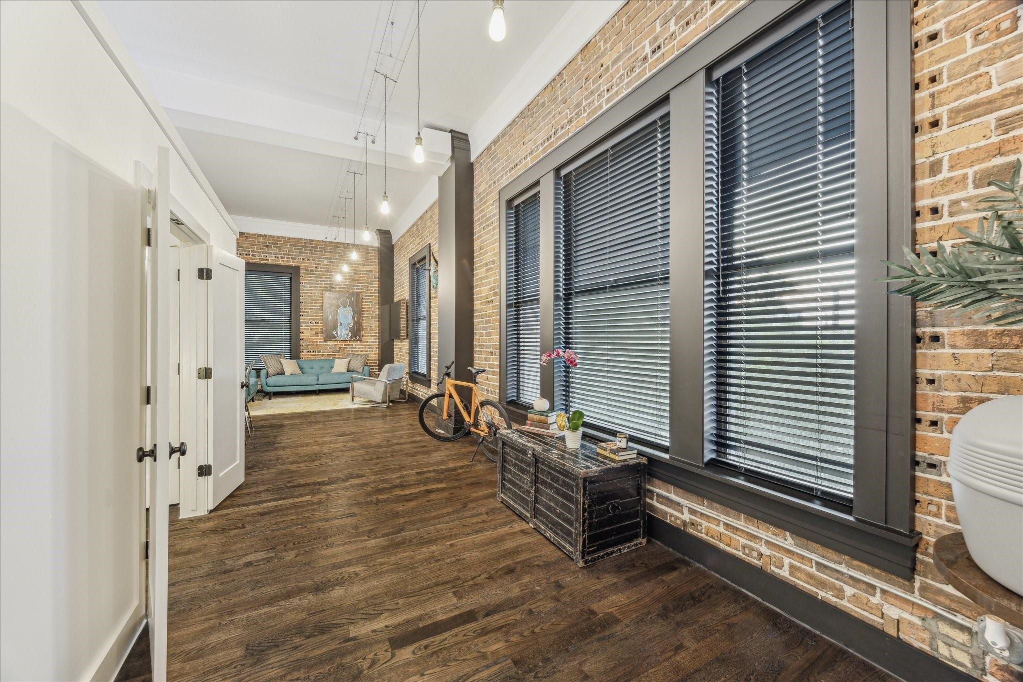 915 Franklin Street, Unit 2F Houston, TX 77002 - Photo 13 of 50 a view of a balcony and chairs and wooden floor
