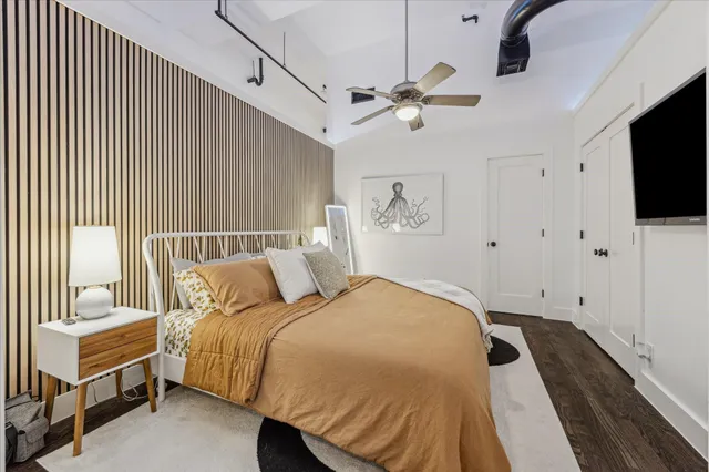 a bed room with a bed and a flat tv screen