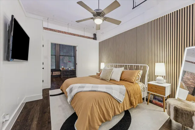 a bedroom with a bed and a flat screen tv