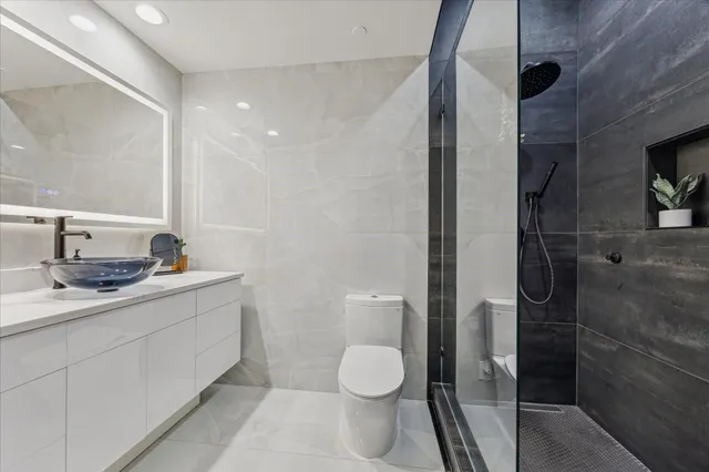 a bathroom with a toilet sink and shower