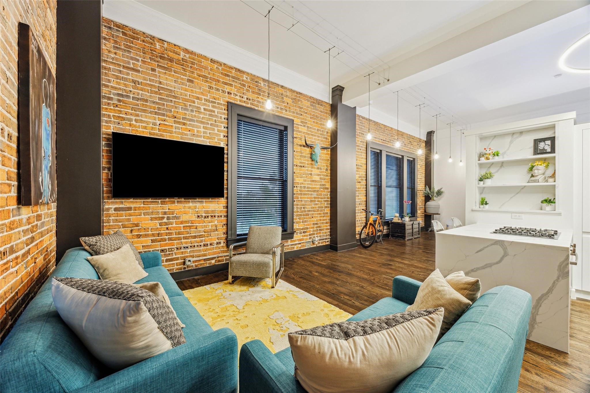 915 Franklin Street, Unit 2F Houston, TX 77002 - Photo 2 of 50 a living room with furniture and a flat screen tv