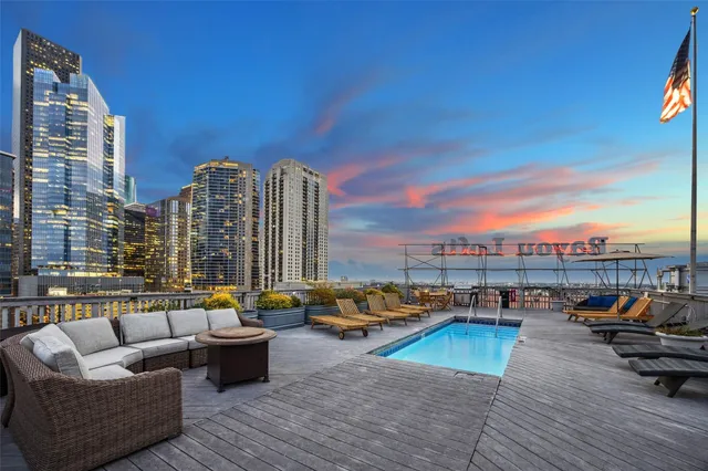 a view of roof deck with seating space and city view