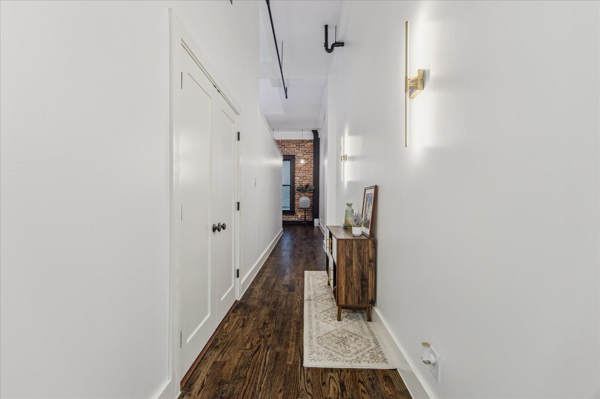 915 Franklin Street, Unit 2F Houston, TX 77002 - Photo 21 of 50 a view of a hallway with wooden floor and staircase