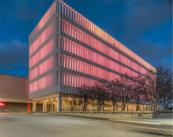 an aerial view of a house with a yard and fountain in middle of the green field