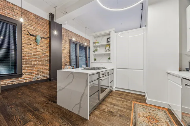 a kitchen with white cabinets and white appliances