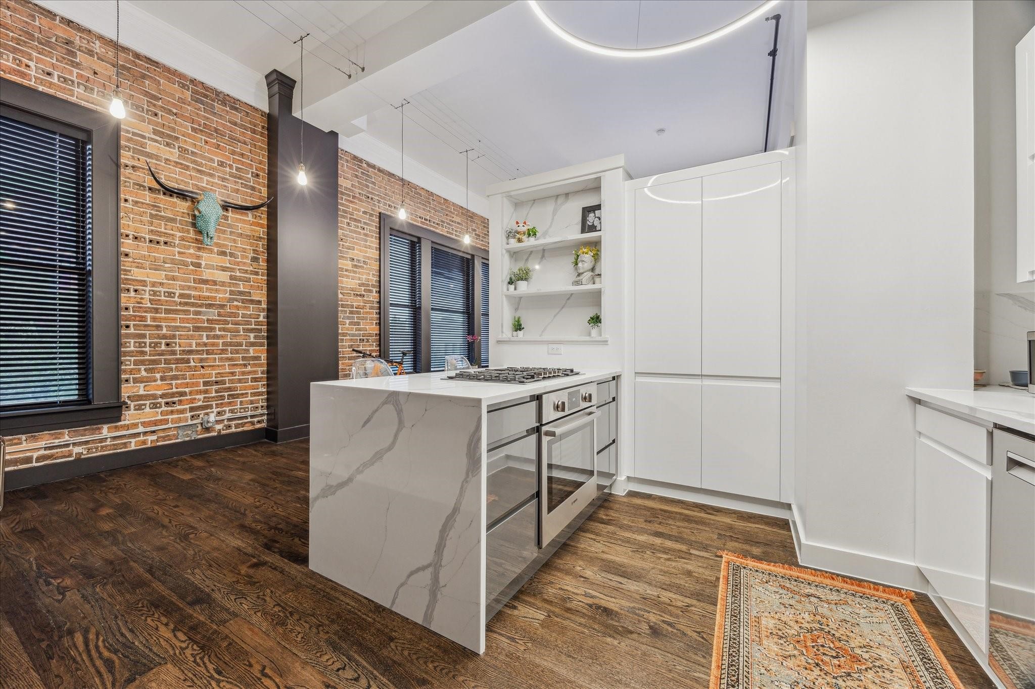 915 Franklin Street, Unit 2F Houston, TX 77002 - Photo 6 of 50 a kitchen with white cabinets and white appliances