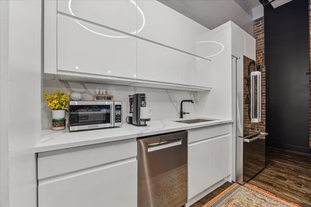 a kitchen with stainless steel appliances a sink and cabinets