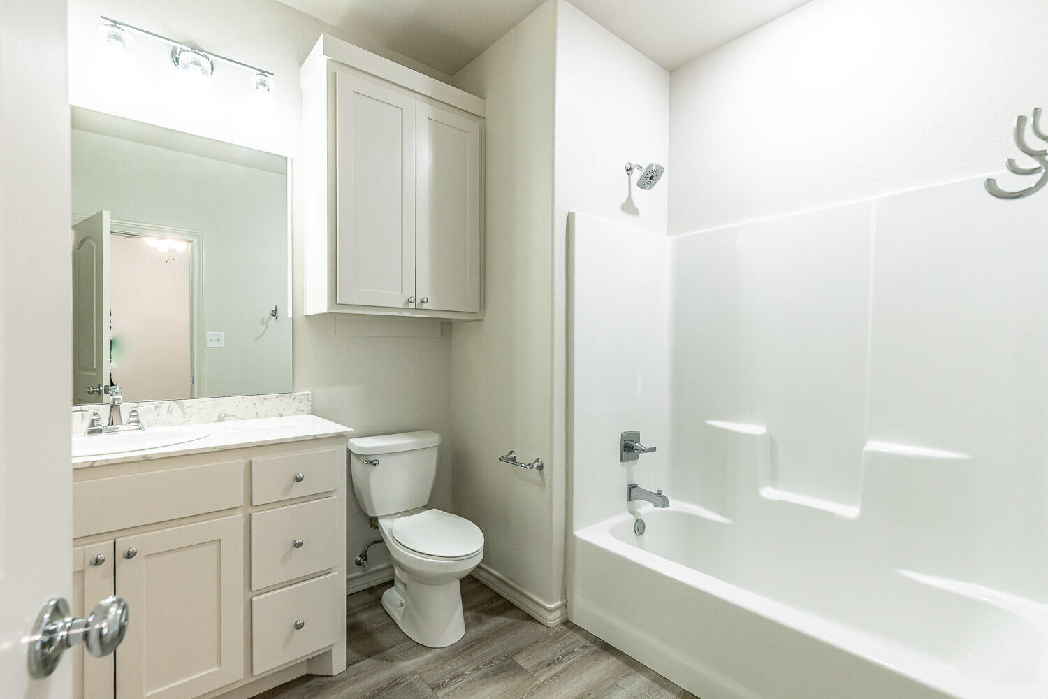 5504 Kemper Street Lubbock, TX 79416 - Photo 11 of 17 a bathroom with a bathtub shower sink mirror and toilet