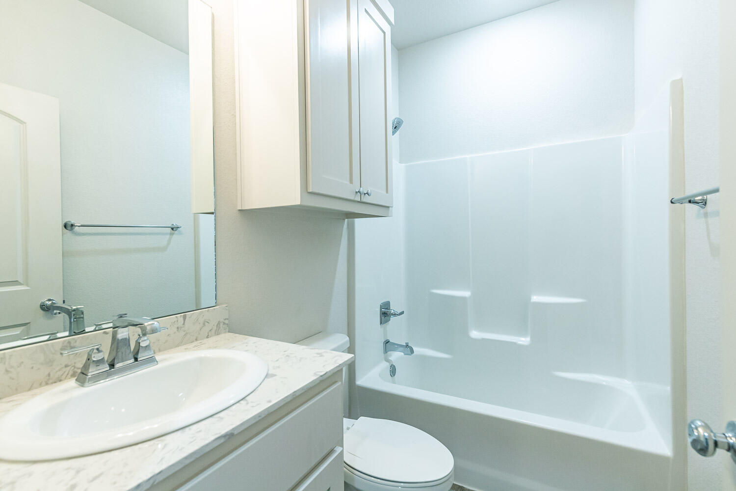 5504 Kemper Street Lubbock, TX 79416 - Photo 14 of 17 a bathroom with a granite countertop sink toilet and shower