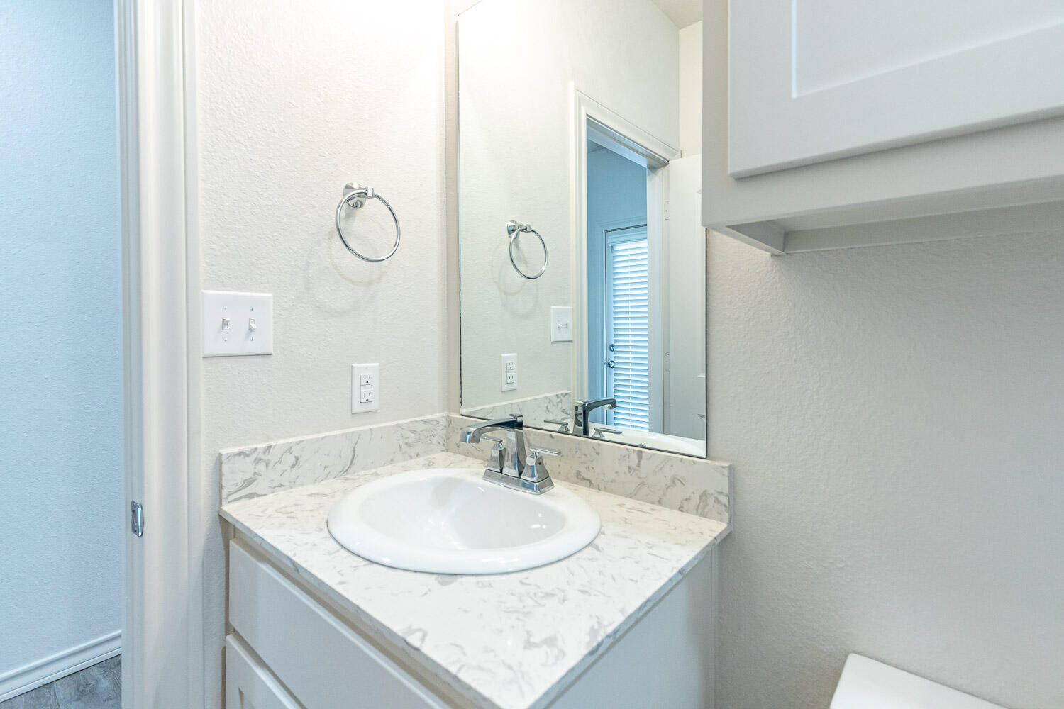 5504 Kemper Street Lubbock, TX 79416 - Photo 15 of 17 a bathroom with a granite countertop sink and a mirror