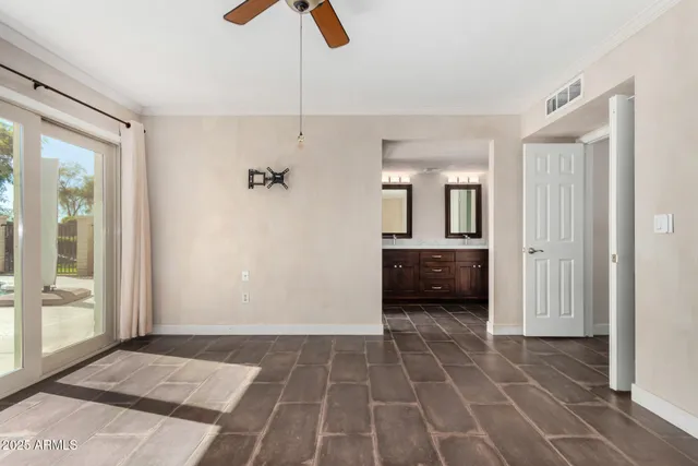 a view of a hallway to a bedroom and a window