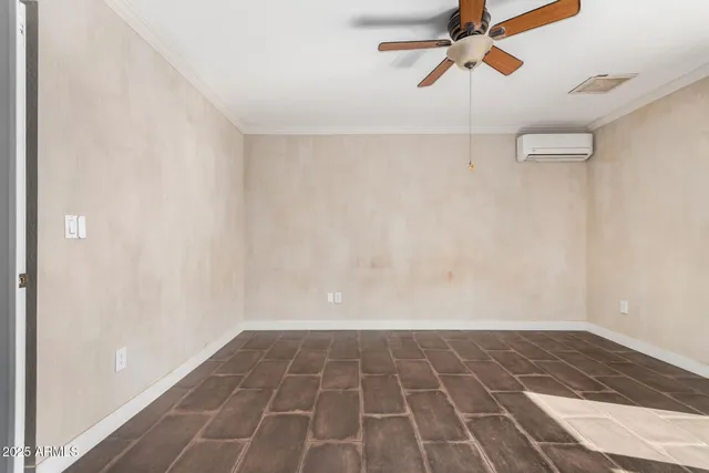 a view of a room with wooden floor and white walls