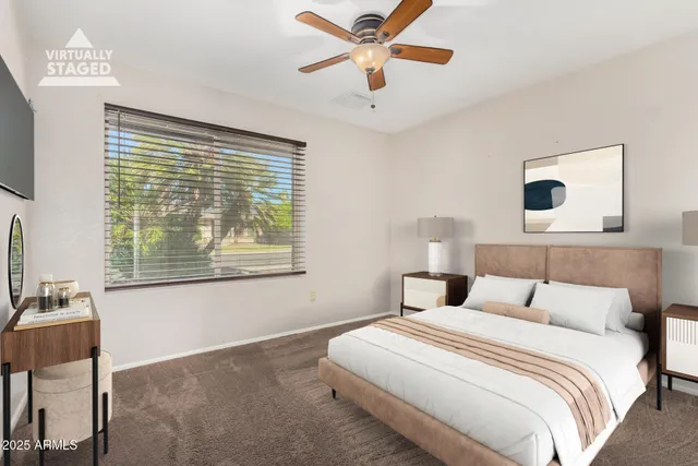 a bedroom with a large bed and a window