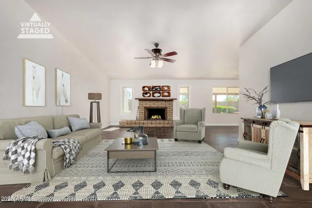 a living room with furniture a fireplace and a flat screen tv