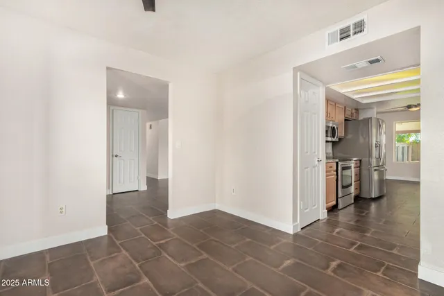 a view of a hallway with a sink and a refrigerator