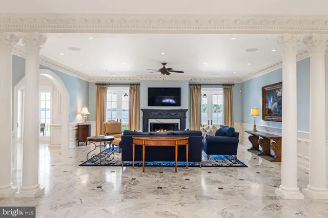 a living room with fireplace furniture and a large window