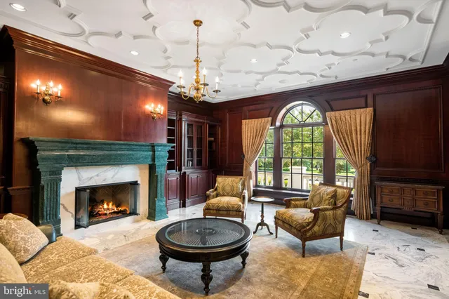 a living room with furniture a window and a fireplace