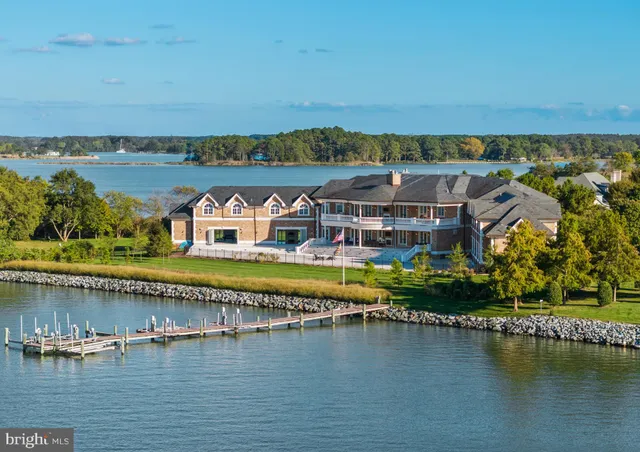 an aerial view of residential building with outdoor space and lake view