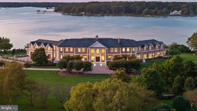 a view of a house with a yard and a pond