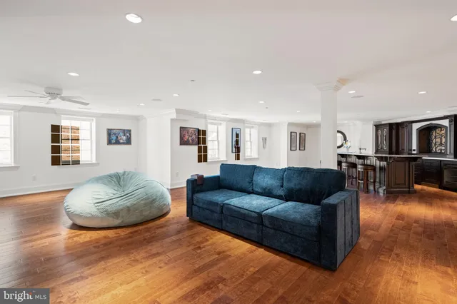 a kitchen with stainless steel appliances granite countertop a sink a stove and a wooden floors