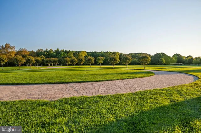 an aerial view of ocean and residential houses with outdoor space
