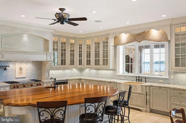 a dining room with stainless steel appliances granite countertop a dining table and chairs with wooden floor