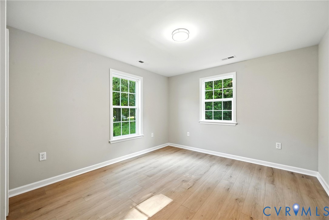 24611 Williamson Road Dinwiddie, VA 23841 - Photo 18 of 30 an empty room with wooden floor and windows