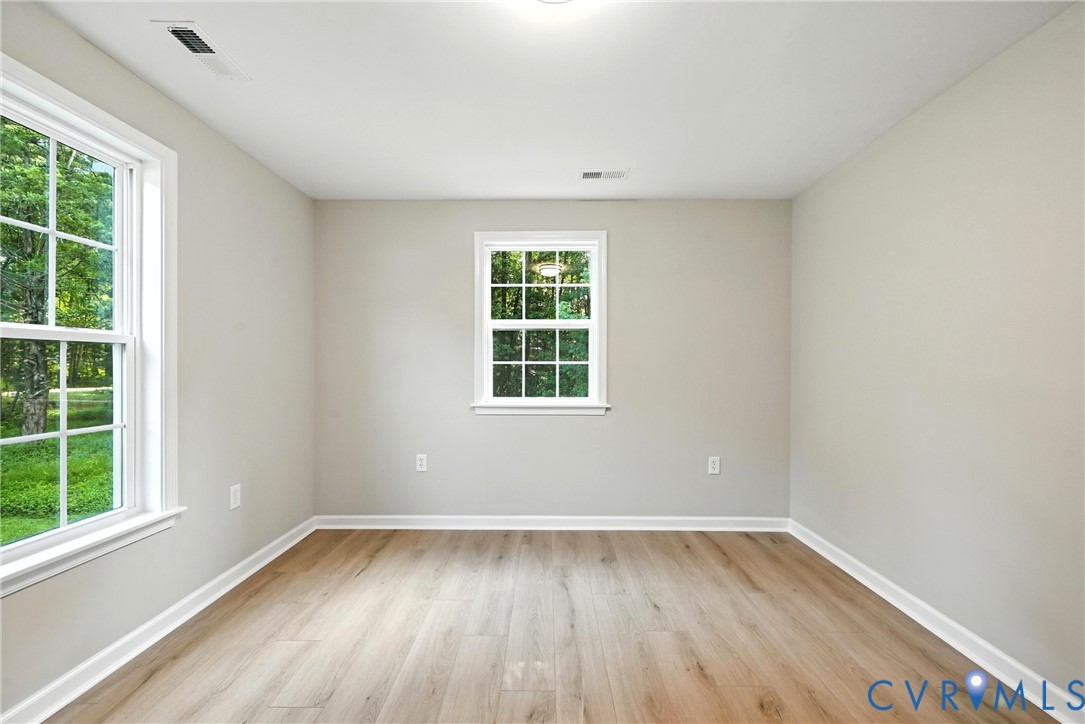 24611 Williamson Road Dinwiddie, VA 23841 - Photo 19 of 30 an empty room with wooden floor and windows