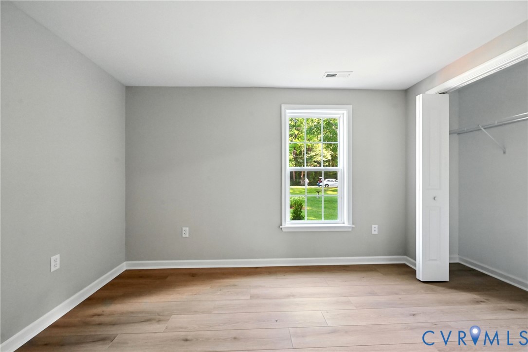 24611 Williamson Road Dinwiddie, VA 23841 - Photo 22 of 30 a view of an empty room with wooden floor and a window